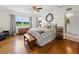 Spacious bedroom with hardwood floors, large windows, and a ceiling fan at 34868 Prospect Rd, Dade City, FL 33525