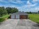 Two-car garage with large concrete driveway at 34868 Prospect Rd, Dade City, FL 33525