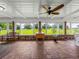 Sunroom boasts brick flooring, serene views, and plenty of natural light at 34868 Prospect Rd, Dade City, FL 33525