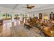 Spacious living area with hardwood floors, a ceiling fan, and comfortable seating at 34868 Prospect Rd, Dade City, FL 33525