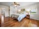Bedroom with wood floors, a ceiling fan, and access to a bathroom at 34868 Prospect Rd, Dade City, FL 33525