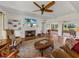 Spacious living room features a fireplace, hardwood floors, and ample natural light at 34868 Prospect Rd, Dade City, FL 33525