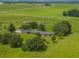 Aerial view showing home's expansive lot and surrounding pasture land at 34868 Prospect Rd, Dade City, FL 33525