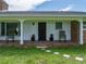 Front porch view of home with brick facade and a dark wood door at 34868 Prospect Rd, Dade City, FL 33525