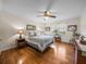 Charming bedroom with wood floors, a ceiling fan, and views of the pasture at 34868 Prospect Rd, Dade City, FL 33525