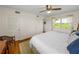 Main bedroom with wood floors and a ceiling fan at 34868 Prospect Rd, Dade City, FL 33525
