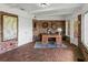 Sunroom with brick walls, brick flooring, and views of the backyard at 34868 Prospect Rd, Dade City, FL 33525