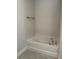 White bathtub with updated faucet and tile flooring at 13260 Ogden Glade Rd, Dade City, FL 33525