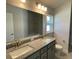 Double vanity bathroom with granite countertops and an updated toilet at 13260 Ogden Glade Rd, Dade City, FL 33525
