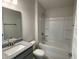 Bathroom with granite vanity, shower/tub combo, and toilet at 13260 Ogden Glade Rd, Dade City, FL 33525