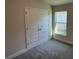 Bedroom with double doors and neutral colored carpet at 13260 Ogden Glade Rd, Dade City, FL 33525