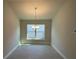 Spacious dining area with tile floor, chandelier, and large window at 13260 Ogden Glade Rd, Dade City, FL 33525