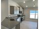 Modern kitchen with gray cabinets, granite countertops, and stainless steel appliances at 13260 Ogden Glade Rd, Dade City, FL 33525