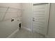 Bright laundry room with shelving, hookups, and door to outside at 13260 Ogden Glade Rd, Dade City, FL 33525