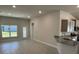 Bright living room with tile floors, access to a back patio, and an open layout at 13260 Ogden Glade Rd, Dade City, FL 33525