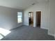Main bedroom with carpet flooring, large window, and en-suite bathroom at 13260 Ogden Glade Rd, Dade City, FL 33525