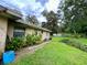 Single story home with AC unit and tropical plants at 16551 Powerline Rd, Dade City, FL 33523