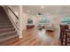 Open living room showcasing hardwood floors, neutral color palette, and staircase at 9293 Rally Spring Loop, Wesley Chapel, FL 33545