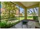 Relaxing screened porch with comfortable seating and a view of the garden at 17012 Vilesta Dr, Lutz, FL 33548