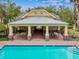 Community pool with adjacent clubhouse and patio at 17012 Vilesta Dr, Lutz, FL 33548