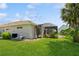 Home exterior showcasing pool equipment and lush landscaping at 9336 Melody Cir, Port Charlotte, FL 33981