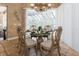 Casual dining area with glass table and chairs, adjacent to pool views at 9336 Melody Cir, Port Charlotte, FL 33981