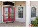 Elegant entryway with double red doors at 9336 Melody Cir, Port Charlotte, FL 33981