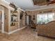 Living room with built-in shelving and view into kitchen and dining areas at 9336 Melody Cir, Port Charlotte, FL 33981