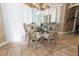 Bright dining room with glass-top table and upholstered chairs, near sliding doors at 9336 Melody Cir, Port Charlotte, FL 33981