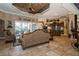 Spacious living room boasts a luxurious sofa and access to the pool area at 9336 Melody Cir, Port Charlotte, FL 33981