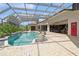Relaxing pool and patio area, screened and surrounded by tropical plants at 9336 Melody Cir, Port Charlotte, FL 33981