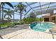 Spacious pool area with screened enclosure, overlooking a canal at 9336 Melody Cir, Port Charlotte, FL 33981