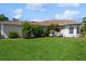 Single story home with manicured lawn and lush landscaping at 9336 Melody Cir, Port Charlotte, FL 33981