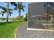 Screened-in pool and patio area with lush landscaping at 9336 Melody Cir, Port Charlotte, FL 33981