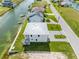 Aerial view of a house with a metal roof and paved driveway at 3455 Sheephead Dr, Hernando Beach, FL 34607