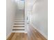 Modern light wood and white staircase in a bright hallway at 3455 Sheephead Dr, Hernando Beach, FL 34607