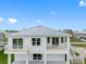 Rear view of a two-story house with balconies and a metal roof at 3455 Sheephead Dr, Hernando Beach, FL 34607