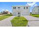 Two-story house with white exterior, two-car garage, and landscaped lawn at 3455 Sheephead Dr, Hernando Beach, FL 34607