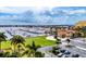 Stunning aerial view of the marina with lush green spaces and luxurious waterfront buildings on a sunny day at 130 Riviera Dunes Way # 403, Palmetto, FL 34221