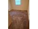 Spacious carpeted bedroom with a window and neutral walls at 5023 6Th St, Zephyrhills, FL 33542