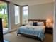 Spacious condo bedroom with king-size bed and balcony access at 130 Riviera Dunes Way # 403, Palmetto, FL 34221