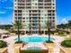 Resort-style pool with spa and plenty of lounge chairs at 130 Riviera Dunes Way # 403, Palmetto, FL 34221