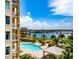 Resort-style pool with water view and relaxing patio area at 130 Riviera Dunes Way # 403, Palmetto, FL 34221