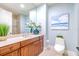 Upscale bathroom with wood vanity, granite countertop, and walk-in shower at 130 Riviera Dunes Way # 403, Palmetto, FL 34221