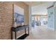 Elegant entryway with decorative wall and modern console table at 130 Riviera Dunes Way # 403, Palmetto, FL 34221
