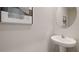 Small bathroom with pedestal sink and mirror at 5026 Captain Davis Dr, Wimauma, FL 33598