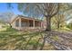 Beautifully landscaped backyard featuring a screened-in lanai at 1145 Almondwood Dr, Trinity, FL 34655