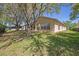 Charming home featuring a screened lanai and manicured backyard at 1145 Almondwood Dr, Trinity, FL 34655