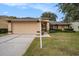 Charming single-story home featuring a two-car garage, manicured lawn, and inviting front entrance at 1145 Almondwood Dr, Trinity, FL 34655