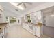 Well-lit kitchen featuring white cabinets, granite countertops, and modern appliances at 1145 Almondwood Dr, Trinity, FL 34655